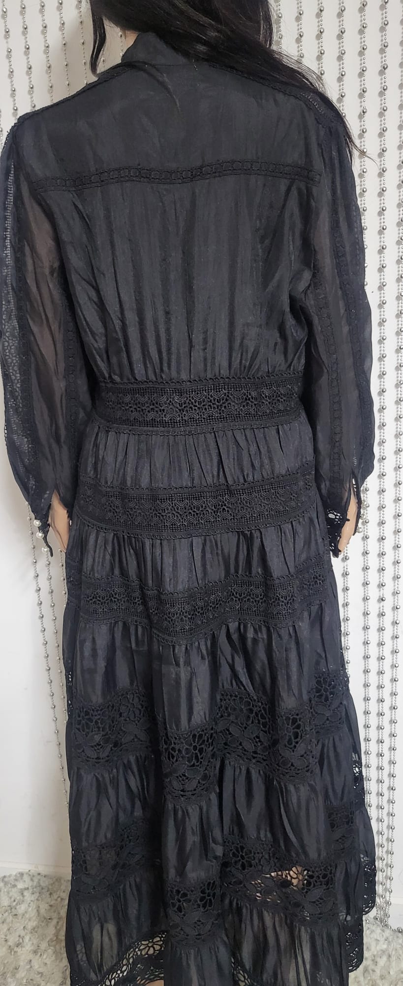 Black embroidered lace pattern dress .