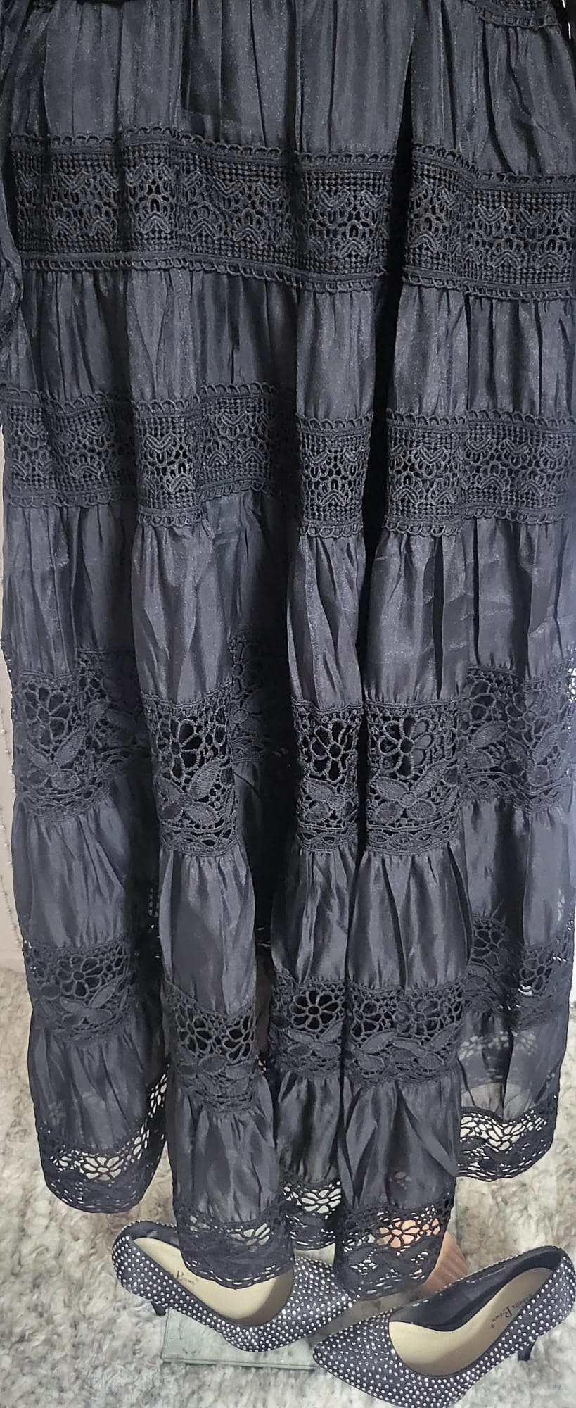 Black embroidered lace pattern dress .