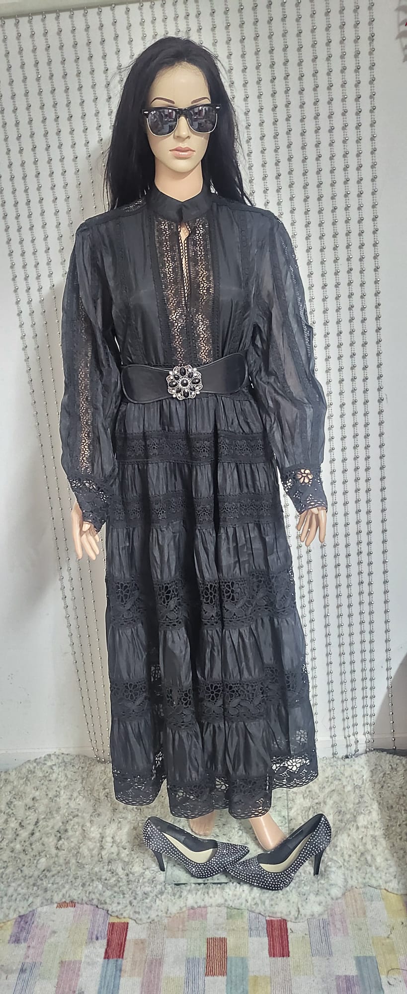 Black embroidered lace pattern dress .