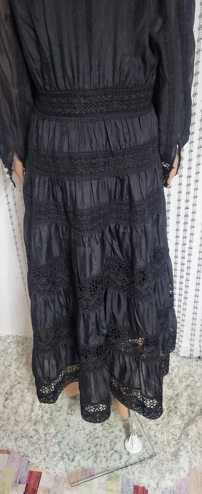 Black embroidered lace pattern dress .