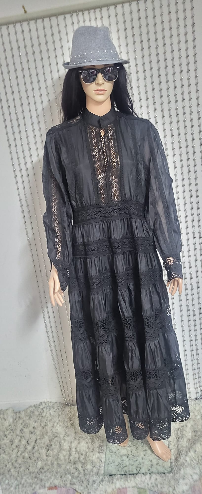 Black embroidered lace pattern dress .