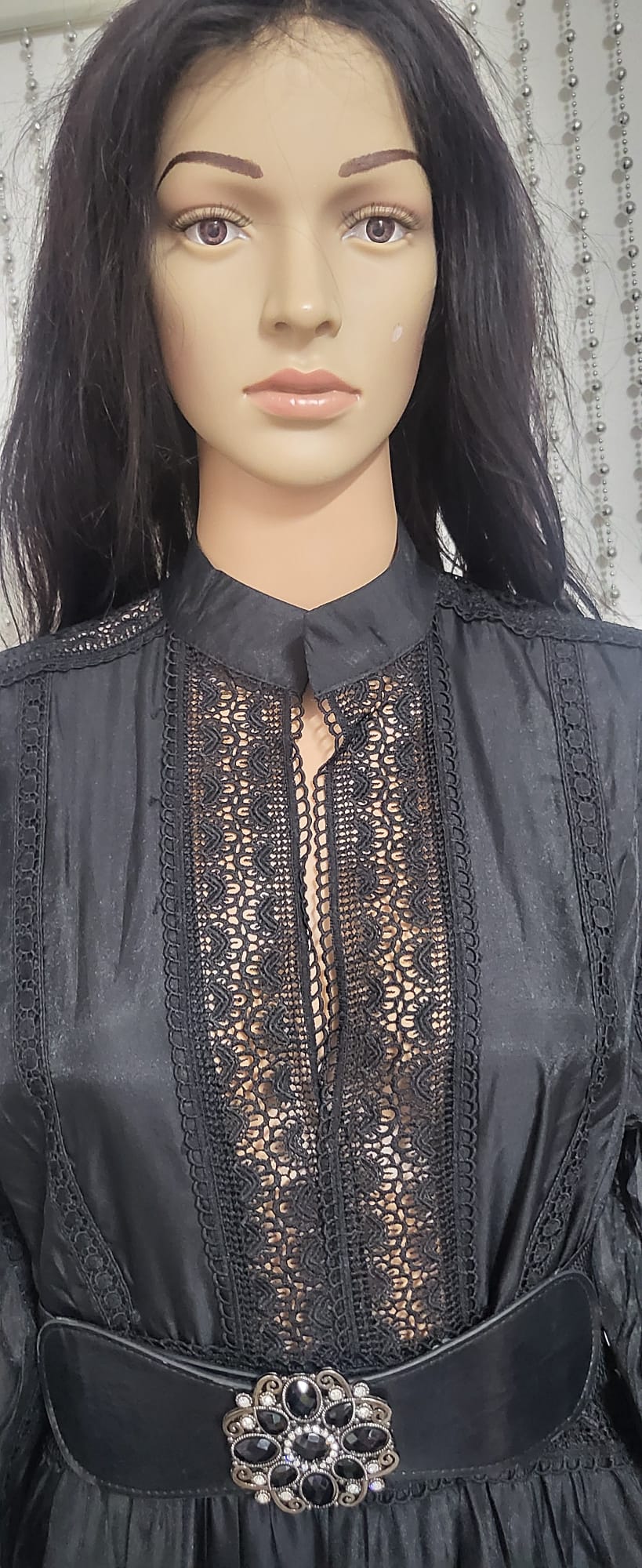 Black embroidered lace pattern dress .